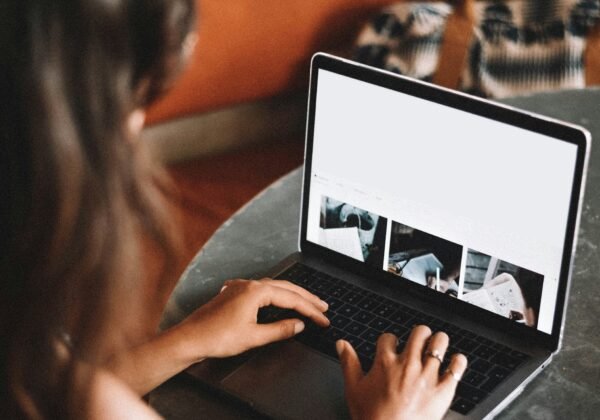 woman using macbook pro on table