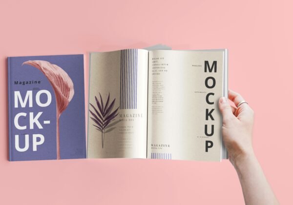 a hand holding a book open to a mockup