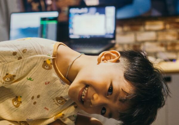 A smiling boy watches kung fu panda.