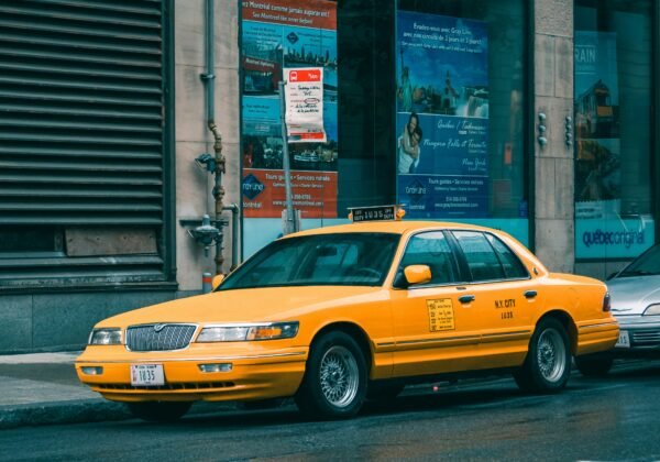 yellow taxi cab on street during daytime