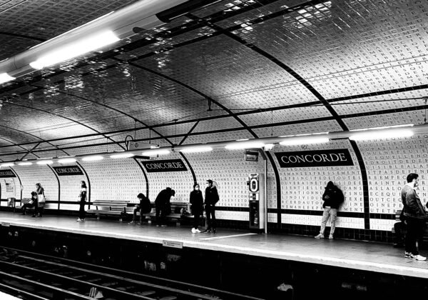 a black and white photo of a subway station
